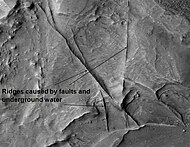 Huo Hsing Vallis Ridges, as seen by HiRISE. Ridges may be caused by water moving along faults.