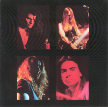 A black image with four portraits of members of the band I AM, the singer holding a microphone, the guitarist leaning back, the bassist obscuring his face with shadow, Frank Klepacki gazing into the camera